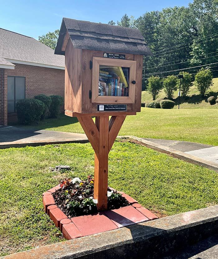 Wooden box with roof and door outside book nook